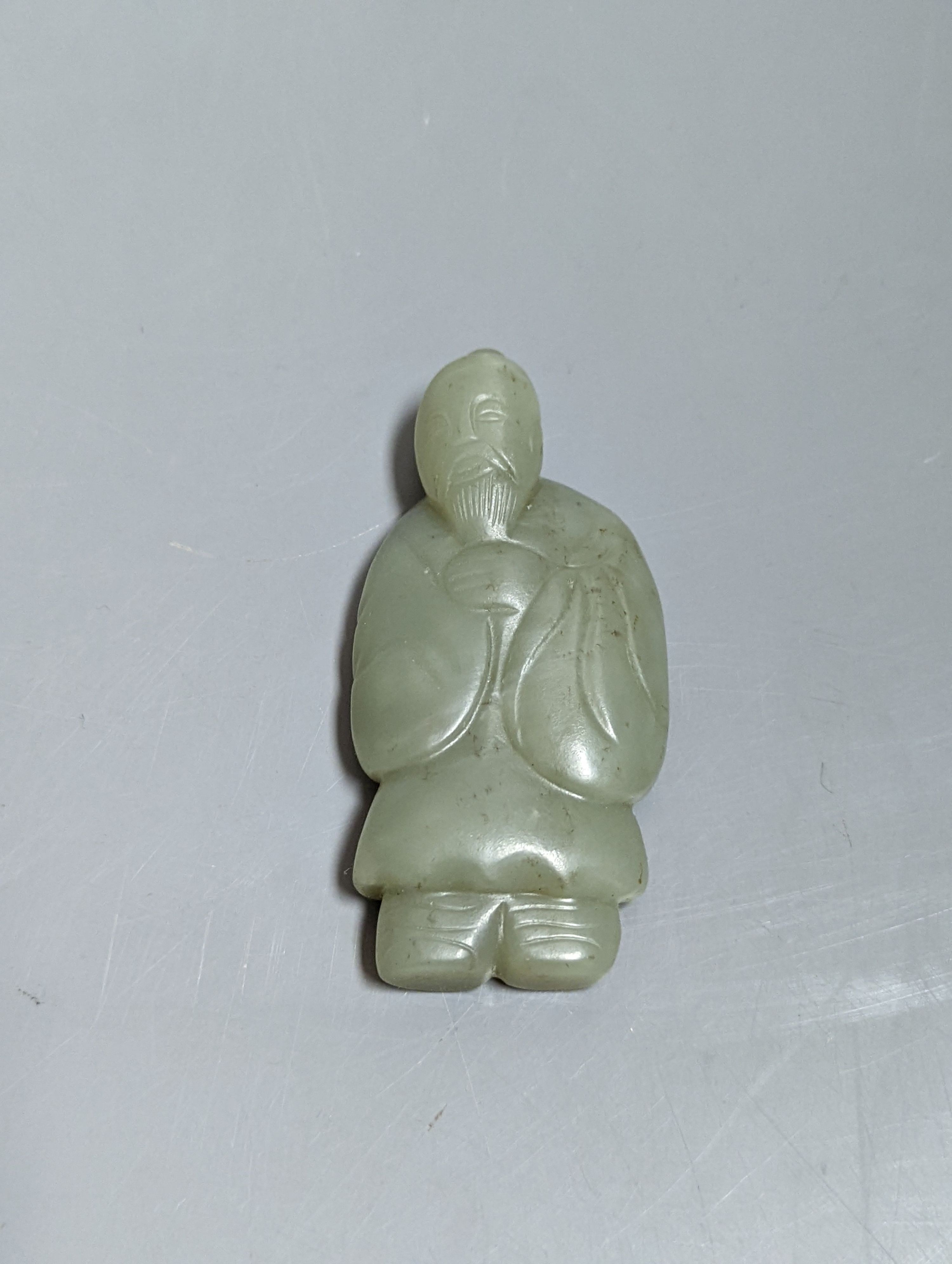 An early 20th century Chinese carved ivory figure of Shao Lao on stand and a jade figural carving 13cm